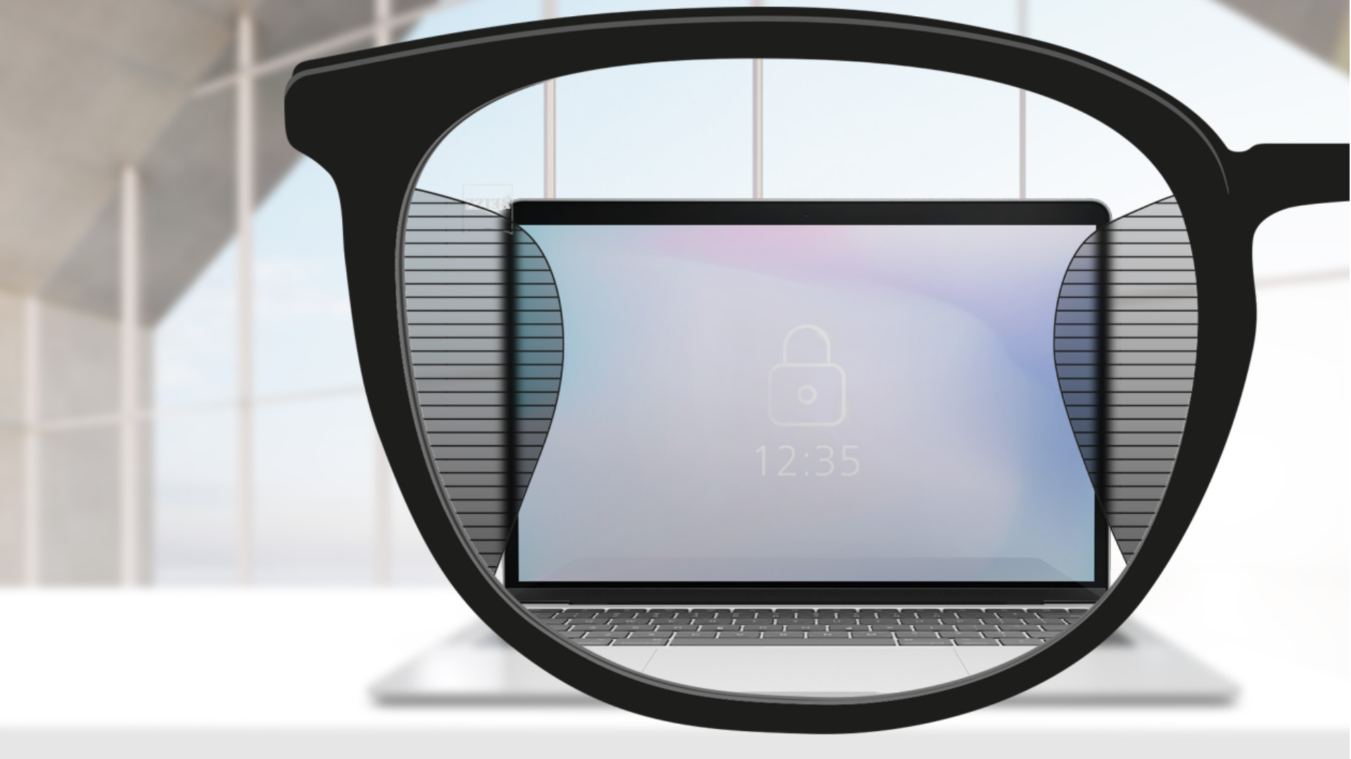 Зображення при погляді крізь лінзи ZEISS Office з екраном комп'ютера в центрі лінзи та вузькими зонами розмитості зліва та справа.