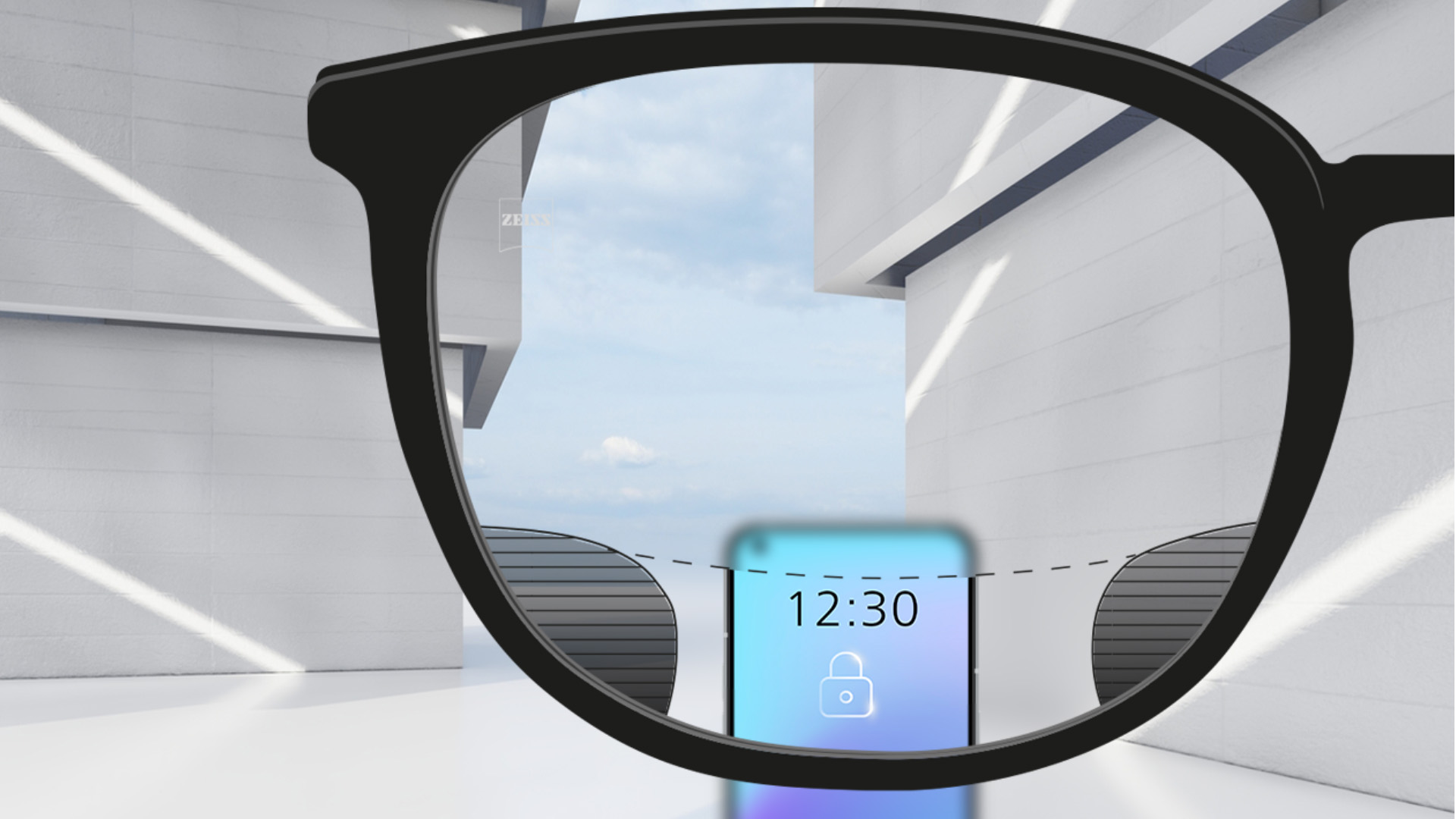 Зображення при погляді крізь лінзи ZEISS Digital SmartLife зі смартфоном; зображення повністю чітке у верхній та нижній частинах лінзи й має невеликі розмиті ділянки зліва та справа.